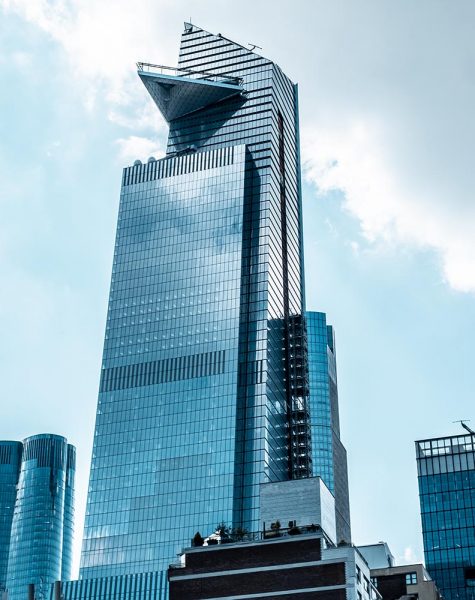 A vertical low angle shot of modern glass business buildings touching the sky